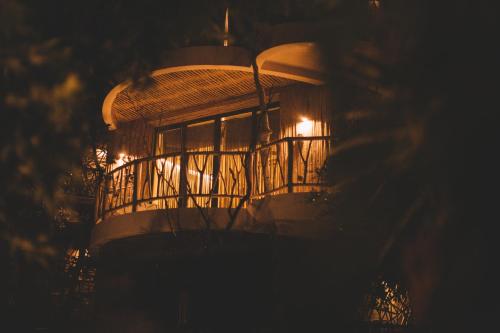 a bird cage with lights in it at night at Kan Tulum Hotel in Tulum