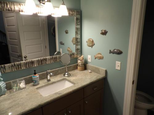 a bathroom with a sink and a mirror at Bike & Beach Bungalow at Oyster Bay-Sunset Beach in Sunset Beach