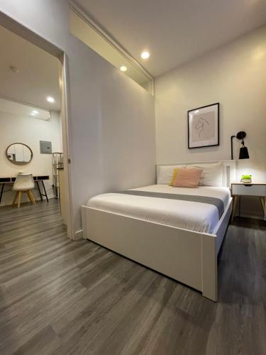 a white bedroom with a bed and a table at Hotel and the City, Empire State Building in New York