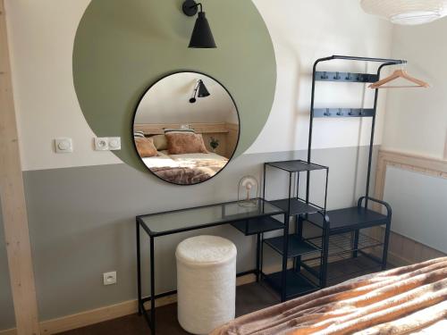 a bedroom with a mirror and a bed at Wioska w Sowich Sokolec in Sokolec