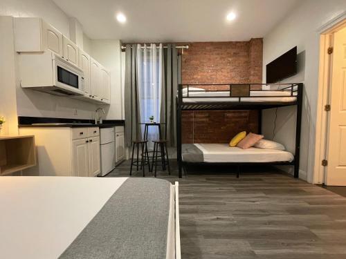 a small room with two bunk beds and a kitchen at Hotel and the City, Empire State Building in New York
