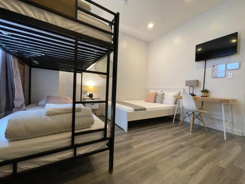 a bedroom with two bunk beds and a desk at Hotel and the City, Empire State Building in New York