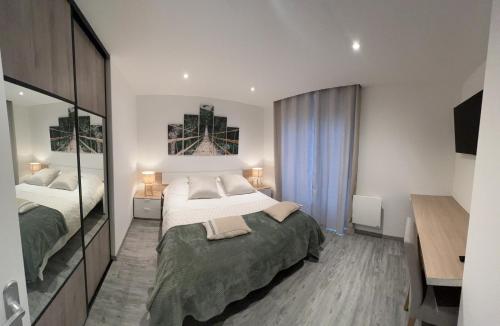 a bedroom with two beds and a mirror at Appartement brest st-marc 6-8personne 2min centre in Brest