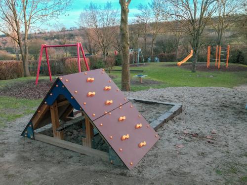 a playground with a play structure in a park at Das Haus am Bach - Schöne große moderne Wohnung mit Terrasse in Osthofen