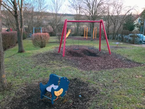 a park with a playground with a swing at Das Haus am Bach - Schöne große moderne Wohnung mit Terrasse in Osthofen