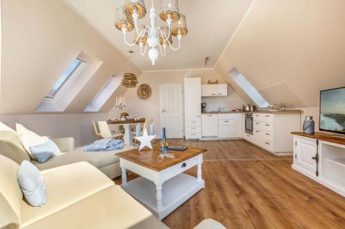 a living room with a couch and a table at Seebrise Zingst in Zingst