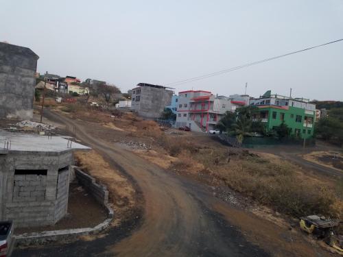 a dirt road in a city with buildings at chez albino guest house in São Filipe