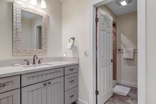 a white bathroom with a sink and a mirror at Endless Summers in Ponte Vedra Beach