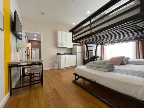 a bedroom with a large bed and a desk in it at Hotel and the City, Empire State Building in New York