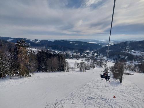 a ski lift going up a snow covered slope at Chalupa a apartmány Marika in Cerny Dul