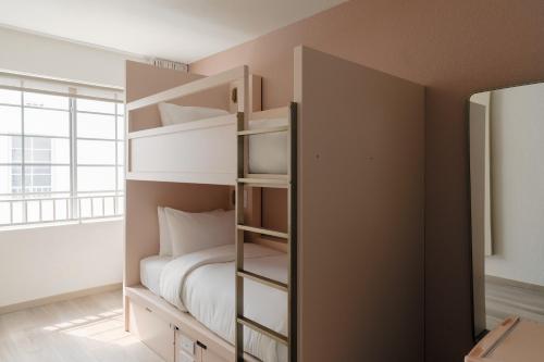 a bedroom with a bunk bed and a large window at Found Miami Beach powered by Sonder in Miami Beach