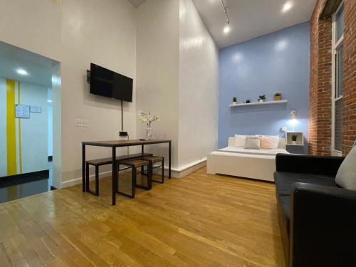 a living room with a bed and a table at Hotel and the City, Empire State Building in New York