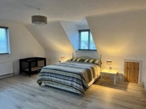 a bedroom with a large bed in a attic at Beach House in Donegal