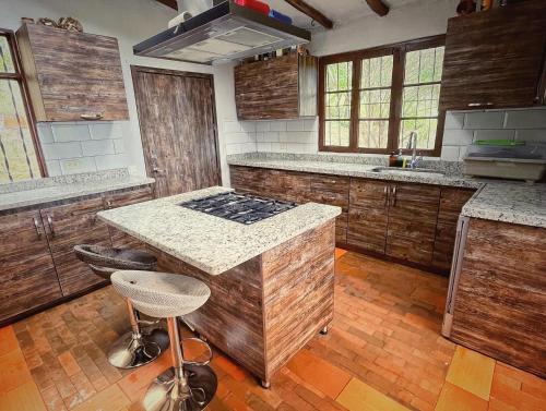 a kitchen with a counter and a stove in it at The Naked House - Hotel Nudista in Nemocón