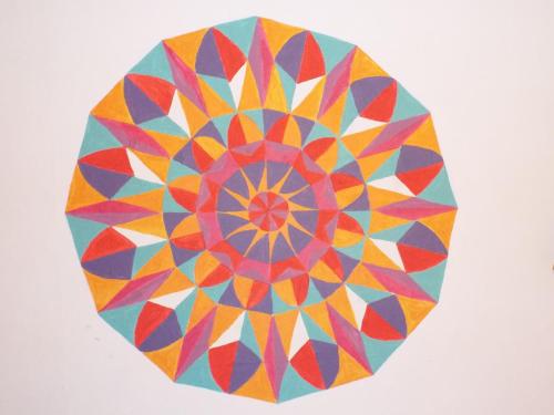 a colorful mandala kite flying in the sky at Hostal Casa Verde Limón in Valparaíso