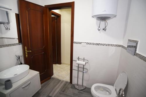 a bathroom with a toilet and a sink at Sicilia Mount&Sea in Mascali