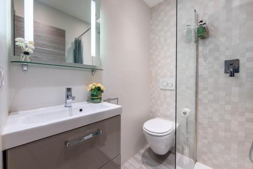 a bathroom with a toilet and a sink and a shower at Nice Centre Flat - Modern, Quiet and Brand New in Nice