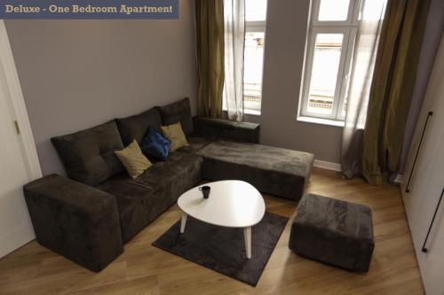 a living room with a couch and a table at Moment Boutique Apartments in Belgrade