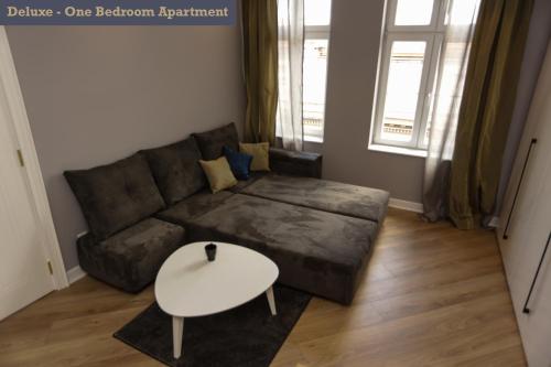 a living room with a couch and a table at Moment Boutique Apartments in Belgrade