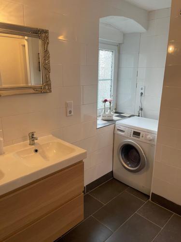 a bathroom with a washing machine and a sink at Villa Lahr in Lahr