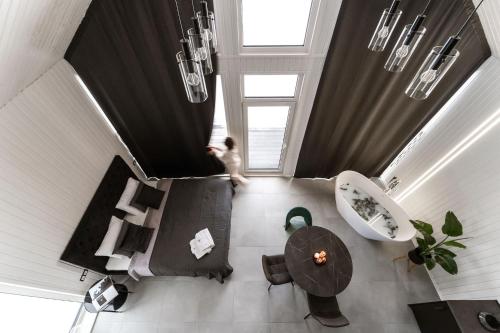 an overhead view of a living room with a table at Sniegi design cabin with sauna in Madona