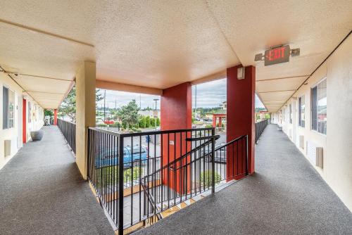 an empty hallway of a building with red columns at Days Inn by Wyndham Federal Way in Federal Way