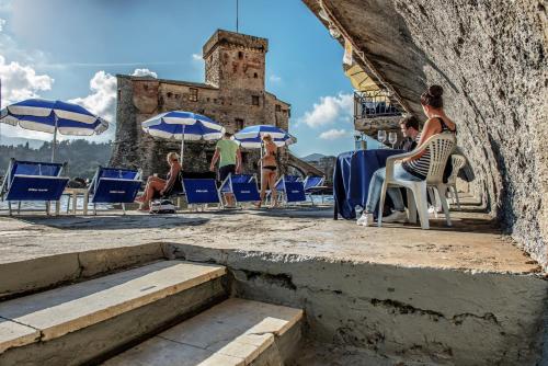 a group of people sitting in chairs in front of a building at Hotel Italia e Lido Rapallo in Rapallo