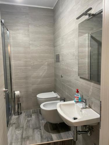 a bathroom with a white toilet and a sink at Savonarola 45_Casa completa nel centro storico in Latronico