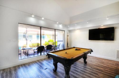 a living room with a pool table and a tv at Las Palmas 1805 Shared Pool and Hot Tub, Great Clubhouse Amenities in St. George