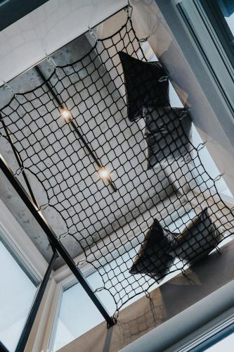 a wire mesh ceiling with two airplanes on it at Forrest Space - wyjątkowy dom otoczony naturą in Wola Rafałowska