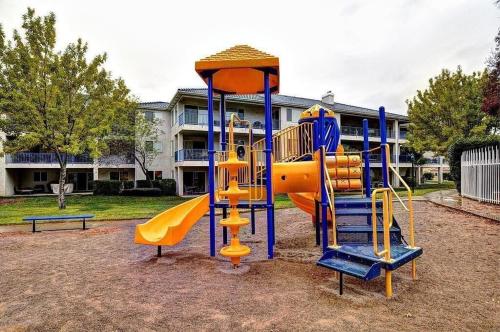 a playground with a slide in a park at 2012 LP PS4, Private Balcony with Beautiful Mountain Views, and Great Clubhouse Amenities in St. George