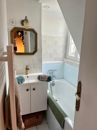 une salle de bain avec un lavabo et une baignoire dans l'établissement Bienvenue à Indra, à Vannes