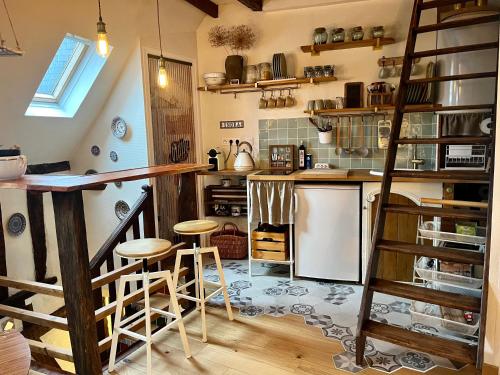 a kitchen with a counter and stools in a room at Bienvenue à Indra in Vannes