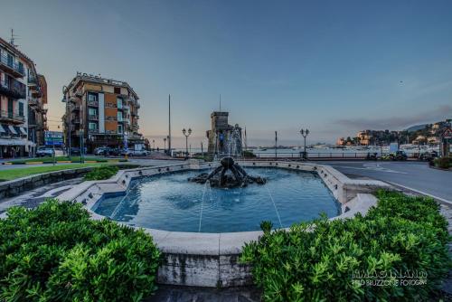 a fountain in the middle of a city at Hotel Italia e Lido Rapallo in Rapallo