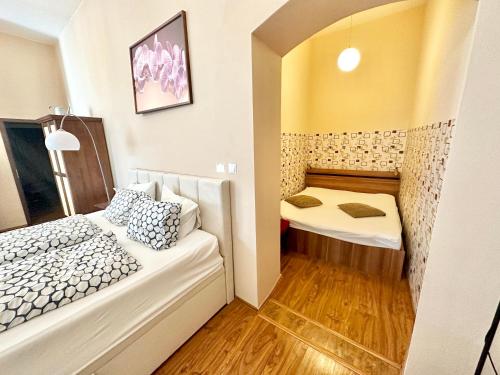 a small room with two beds and a mirror at Home Away central apartment in Poprad