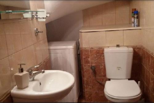 a bathroom with a toilet and a sink at Sofaki Apartments in Thessaloniki