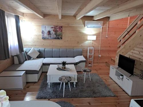 a living room with a couch and a tv at Olive & sea, Luxury two bedrooms cabin for 8 in Ulcinj