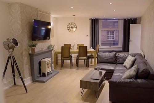 a living room with a couch and a table at Apartment in West Yorkshire 59 in Keighley