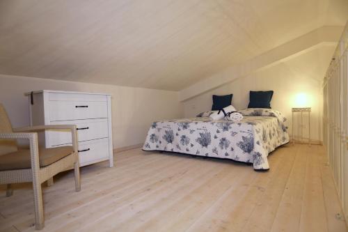 a bedroom with a bed and a dresser at Borgo della Luna in Birgi Vecchi