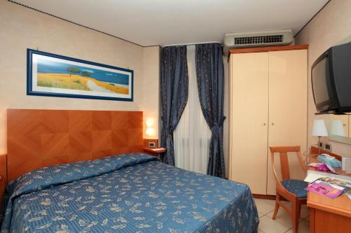a hotel room with a bed and a television at Hotel Centrale in Bologna