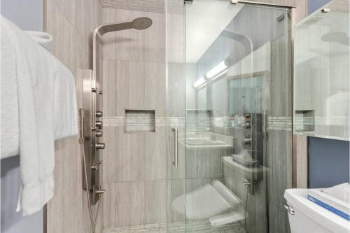 a bathroom with a shower with a glass door at Luxury Modern Townhome steps to ski lifts and downtown with Nature at your patio in Breckenridge
