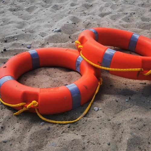 two life tubes on the sand on a beach at Magda Aparthotel Anchoria Mechelinki in Mechelinki