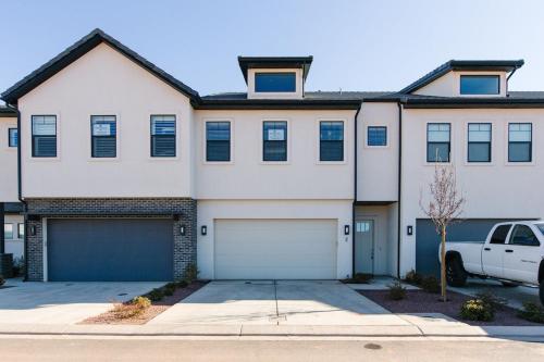 a white house with a car parked in front of it at Ocotillo Springs 2 Includes a Private Hot Tub in Santa Clara