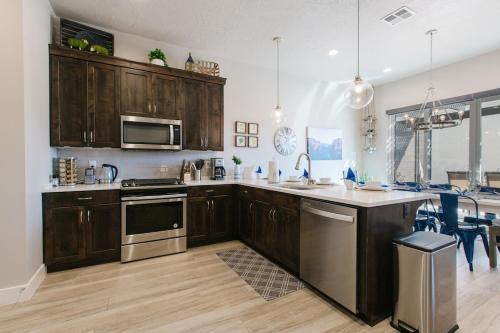 a kitchen with wooden cabinets and stainless steel appliances at Ocotillo Springs 2 Includes a Private Hot Tub in Santa Clara