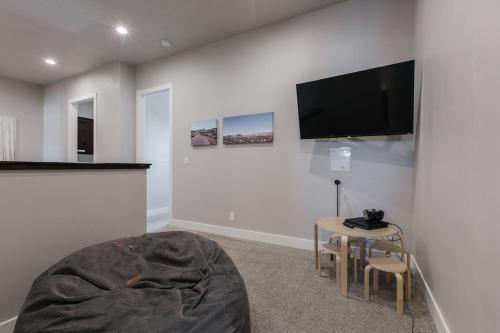a living room with a flat screen tv on a wall at Ocotillo Springs 2 Includes a Private Hot Tub in Santa Clara