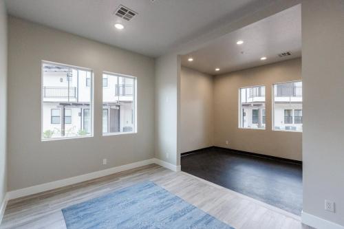 an empty living room with two windows and a blue rug at Ocotillo Springs 2 Includes a Private Hot Tub in Santa Clara