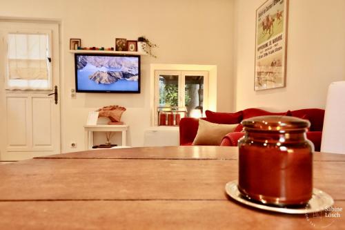 a living room with a table and a living room with a couch at Chez Marcel in Le Vaudreuil