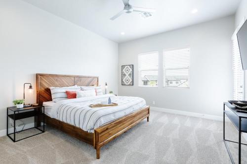 a white bedroom with a large bed and a window at Ocotillo Springs 27 Southern Utah Adventure Paddle Boards, Kayaks, Home Gym, Community Pool and Splash Pad in Santa Clara