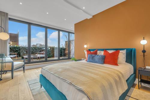 a bedroom with a large bed and a large window at Be London - The Islington Residences in London