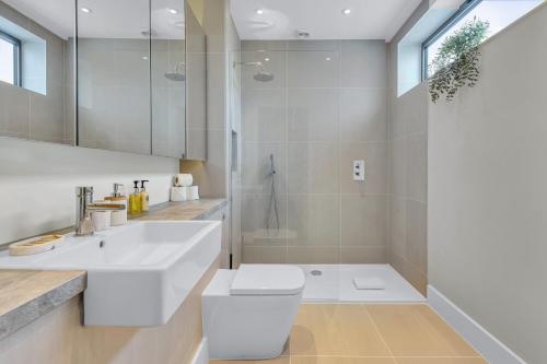 a bathroom with a white sink and a shower at Be London - The Islington Residences in London